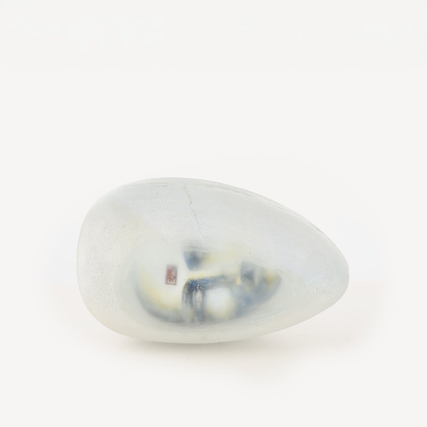 Egg shaped Resting Head 1 Bertil Vallien transparent sculpture with a head inside it.
