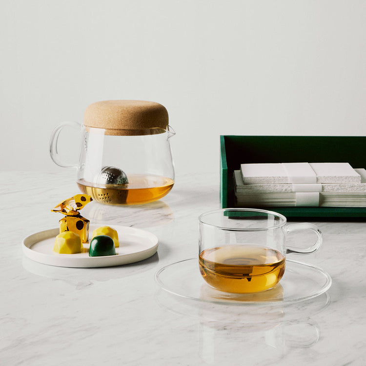 Viva Collection Teapot, tea cup and plate on marble surface with stationery set.