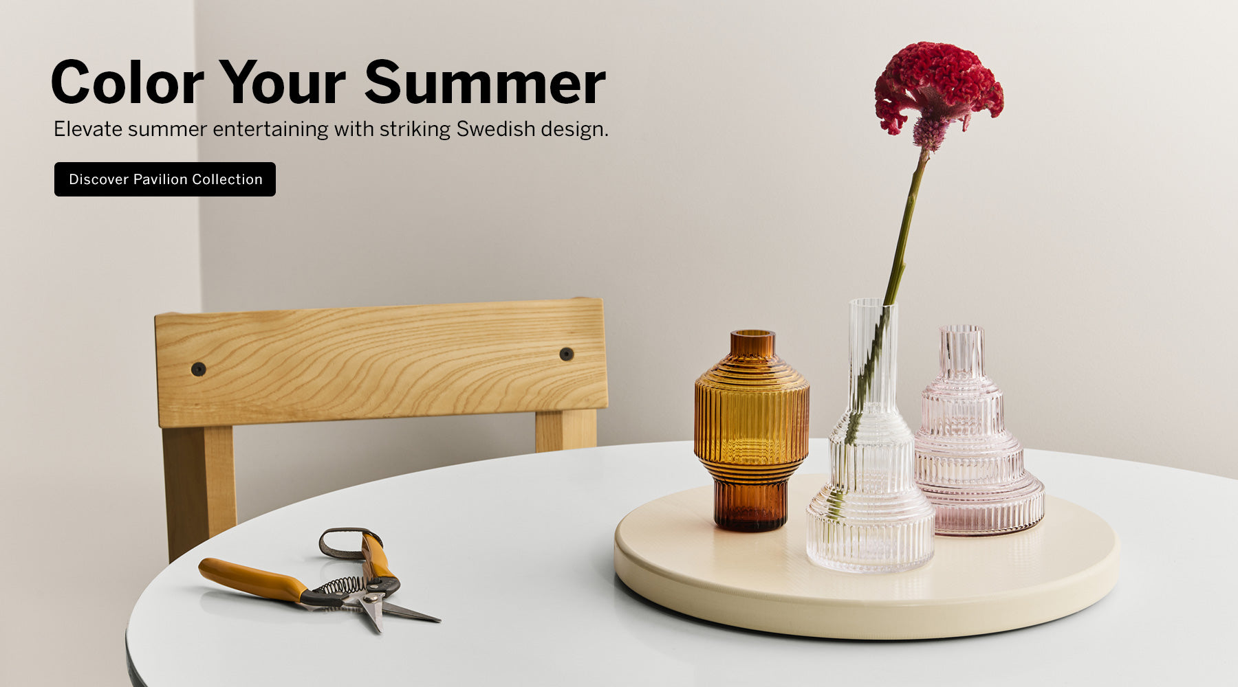 Pavilion collection vases on table with red flower stem in clear vase and text promoting color your summer with Pavilion collection promotion
