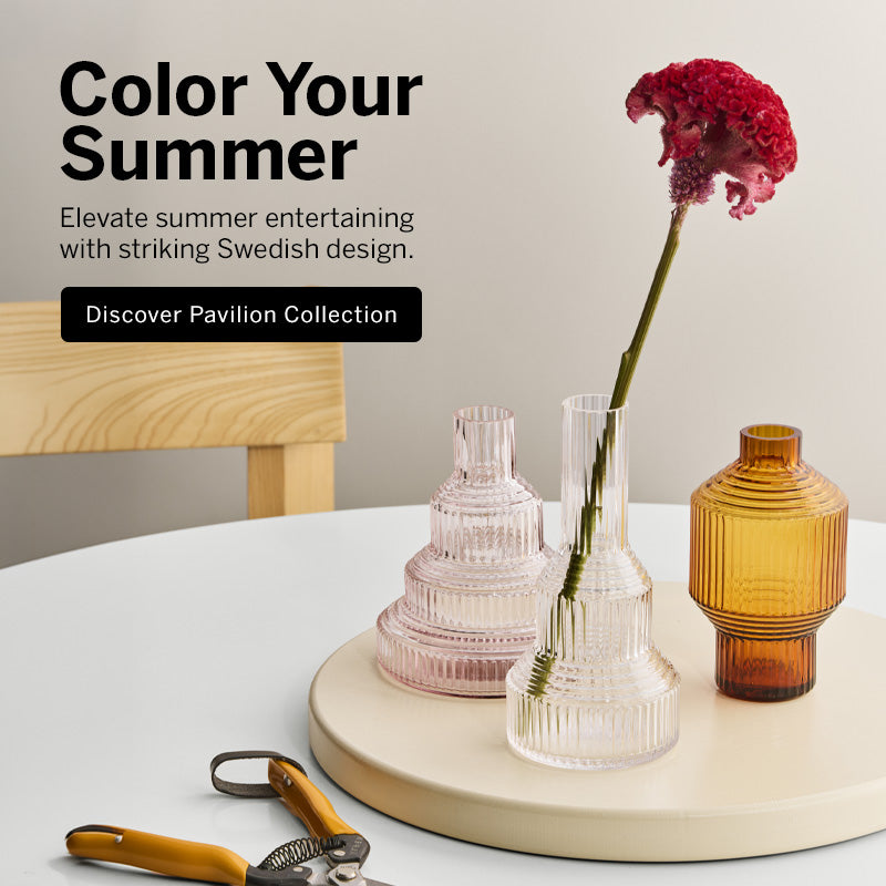 Pavilion collection vases on table with red flower stem in clear vase and text promoting color your summer with Pavilion collection promotion