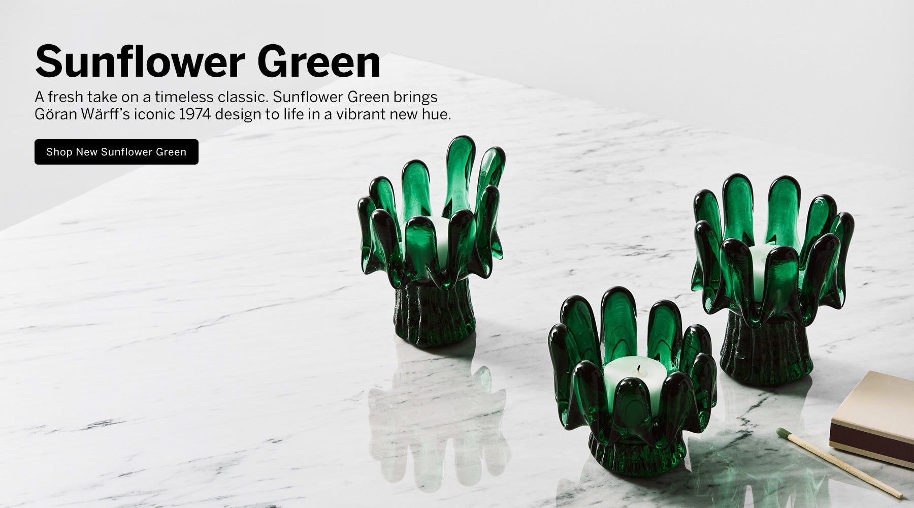 Three green sunflower shaped votives on a marble surface with light background and text explaining Sunflower Green products new introduction, and a button saying 'Shop New Sunflower Green'.