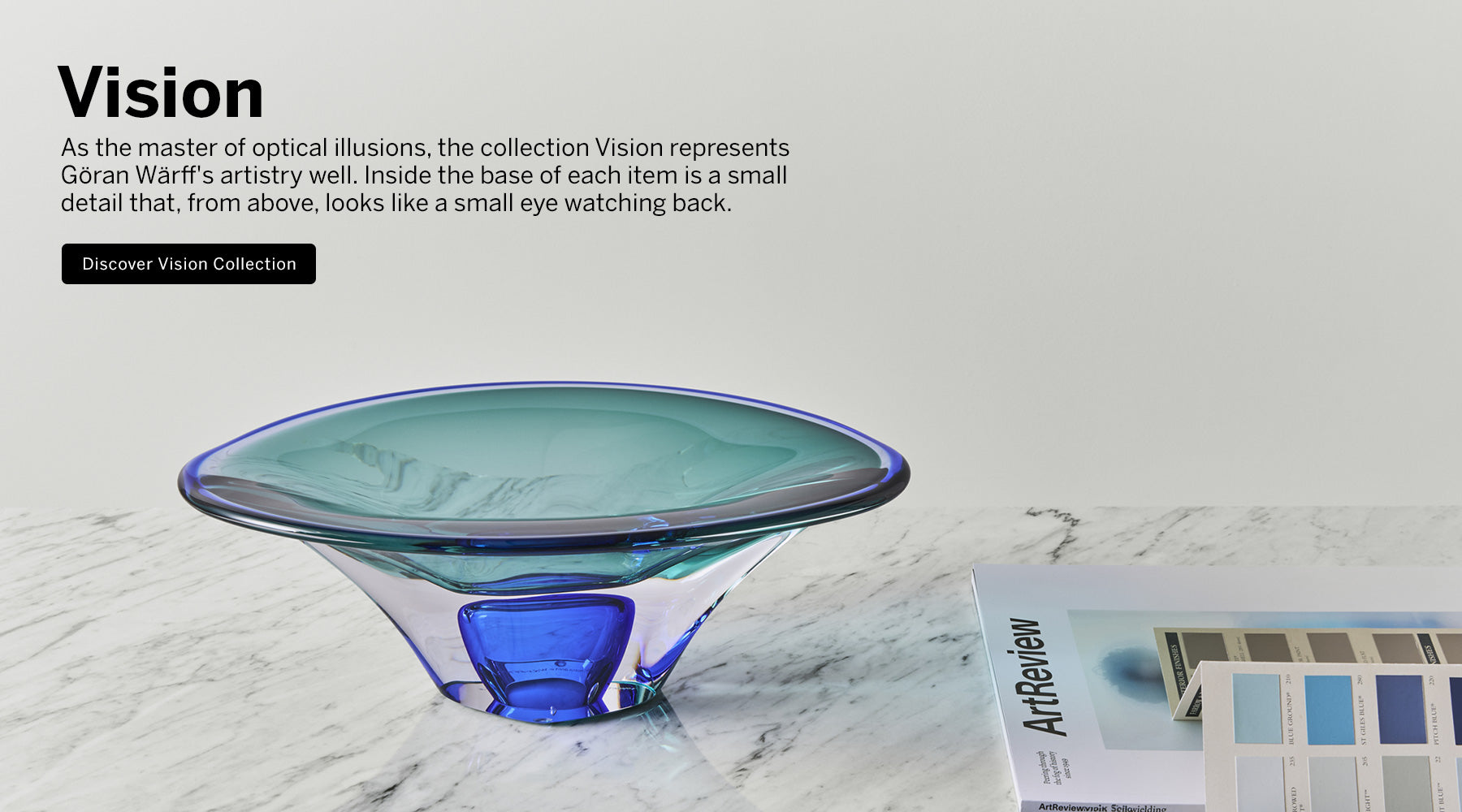 Vision collection crystal bowl with blue and aqua colors in contemporary shape on a marble surface.