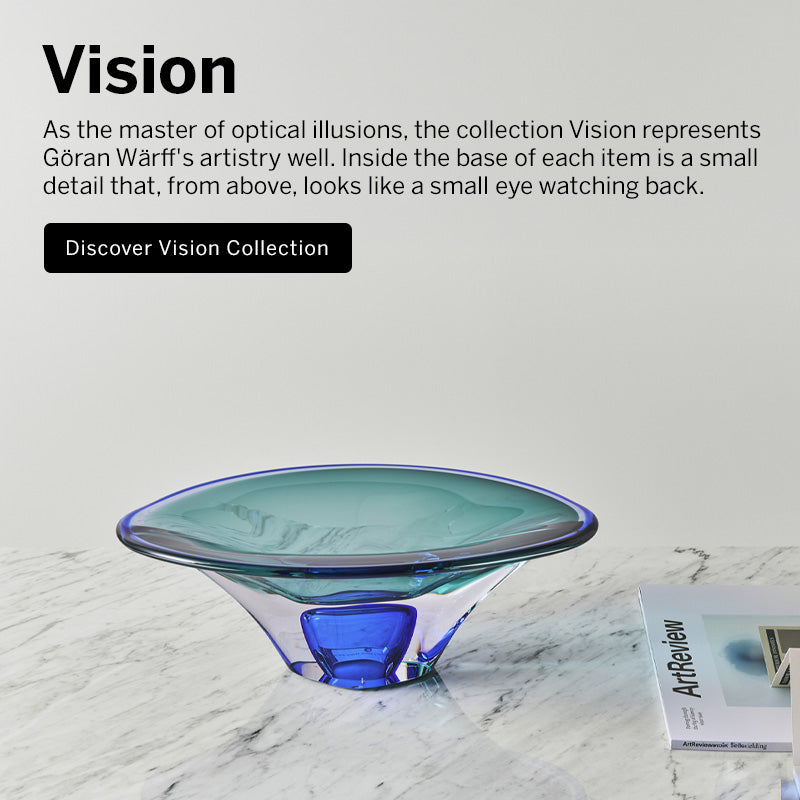 Vision collection crystal bowl with blue and aqua colors in contemporary shape on a marble surface.